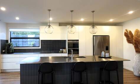 Industrial-inspired kitchen with polished concrete floors, designed by Barrett Joinery.