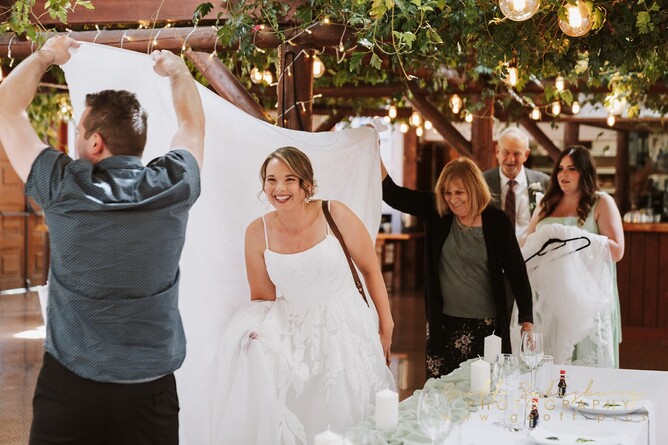 wedding bride hidden by a sheet of cloth