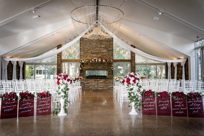 Stunning wet weather indoor wedding ceremony setup at The Fireplace at Markovina Estate in Kumeu