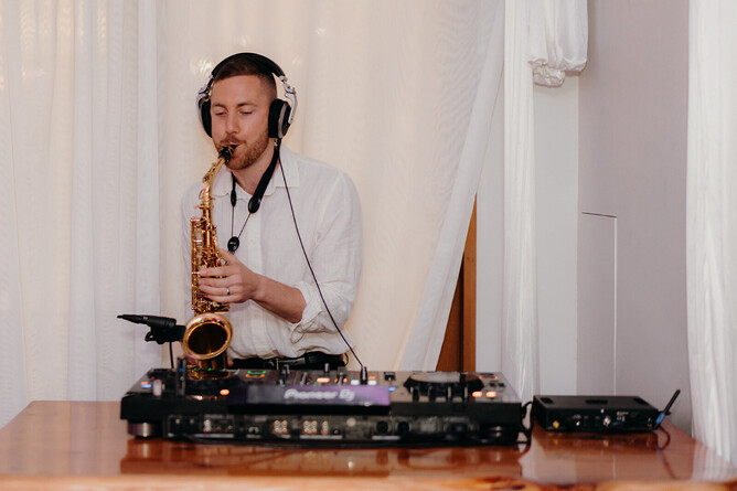 DJ playing music and the saxophone during the wedding reception at Markovina Estate in Kumeu