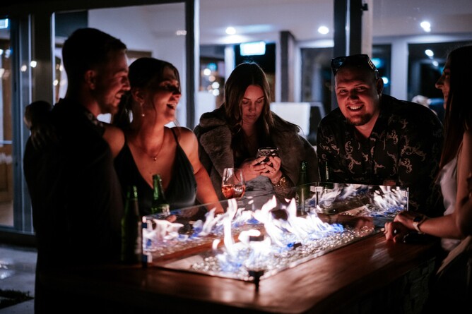 Guests enjoying the firepits at night at Markovina Vineyard Estate in Kumeu