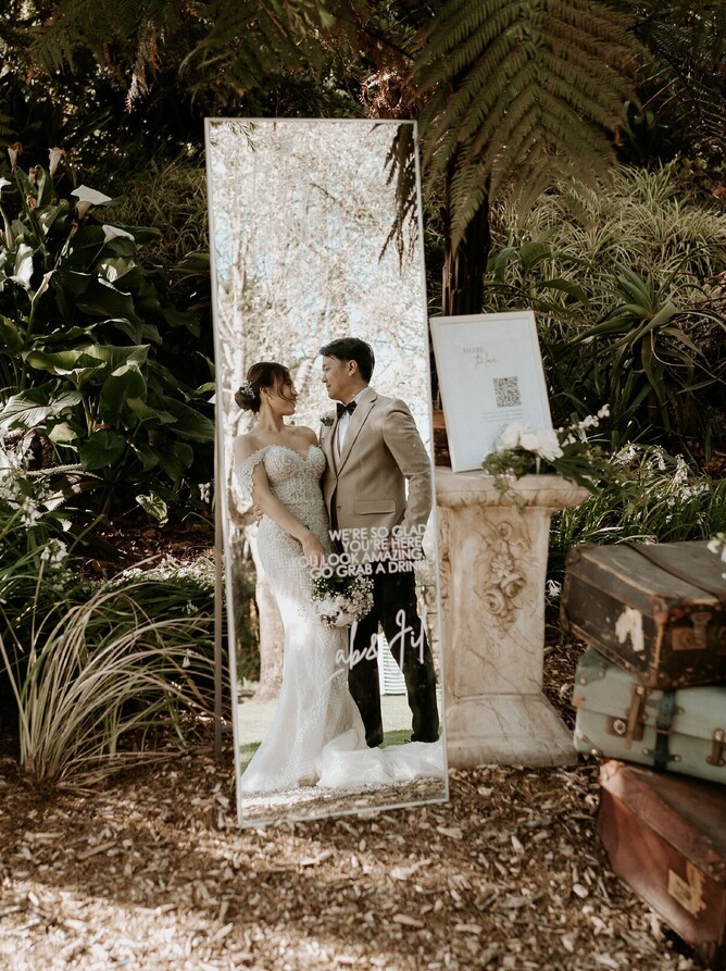 shot of bride and groom through a customized mirror