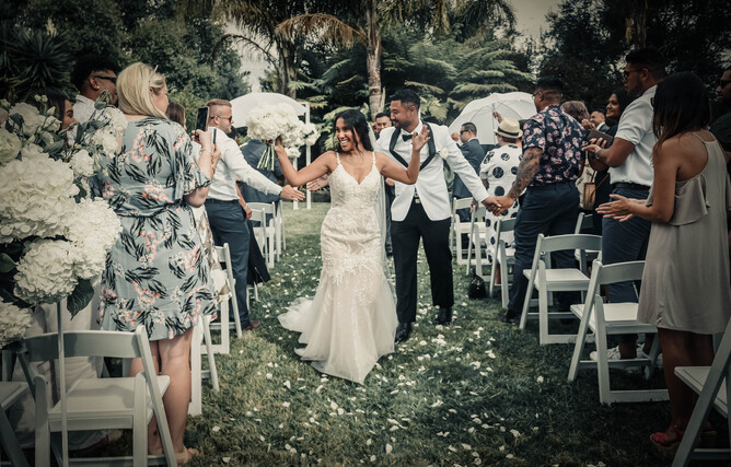 Wedding couple walking down the aisle after their ceremony at The Palms at Markovina Estate in Kumeu