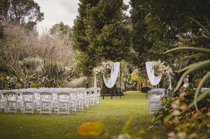 Wedding ceremony setup with white draping at the Two Kauri Trees location at Markovina Estate in Kumeu