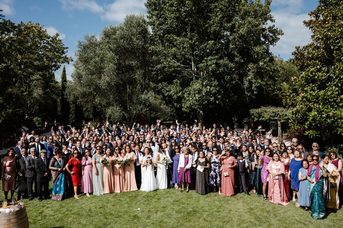 Large wedding group photo in the gardens at Markovina Estate in Kumeu, Auckland