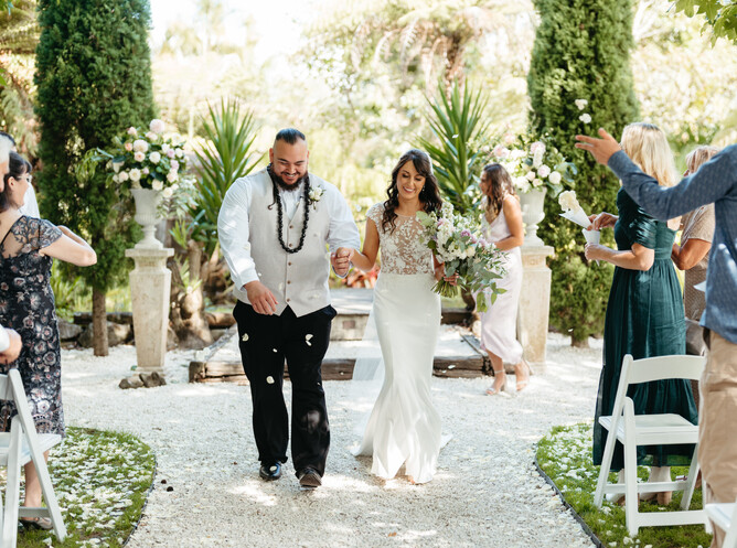 Summer wedding ceremony under the shade at The Barrel Waterfall at Markovina Estate in Kumeu
