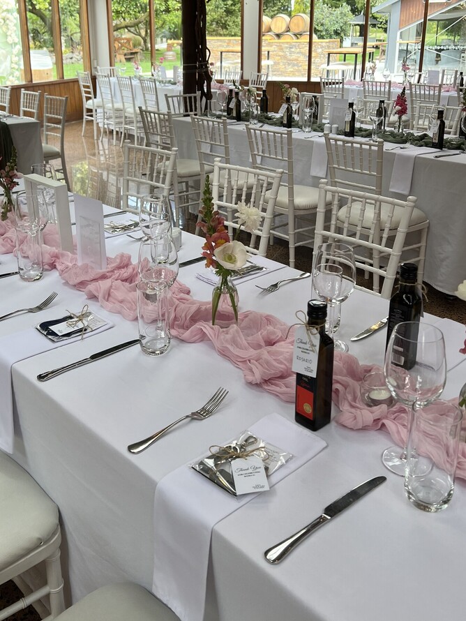 olive oil wedding favors on top of guest tables