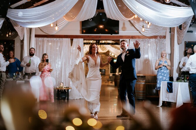 Bride and Groom dancing into the wedding reception after being introduced as a married couple at Markovina Estate in Kumeu