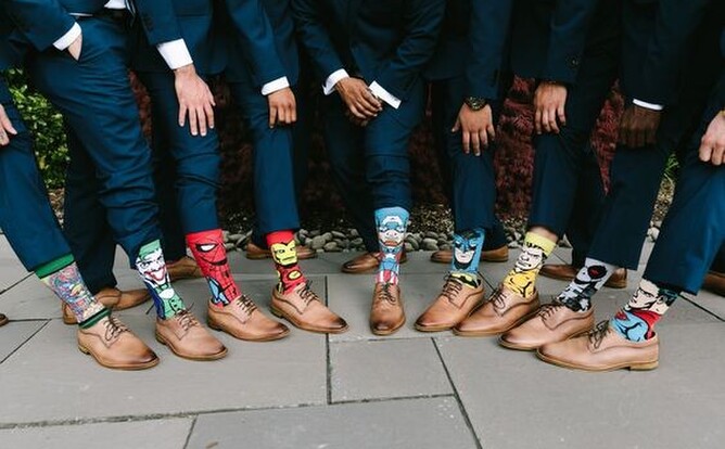 groomsmen wearing superhero themed socks 