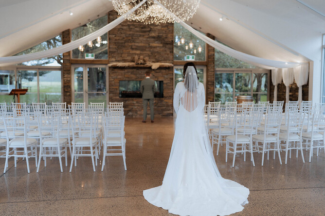 First look bridal photos at the indoor stone fireplace at Markovina Estate in Kumeu