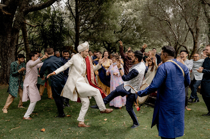 Wedding guests dancing during cocktail hour at wedding at Markovina Estate in Auckland