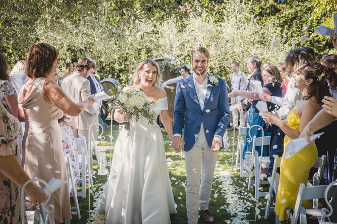 Bride & Groom walking down the aisle after their wedding ceremony at The Barrels at Markovina Estate in Kumeu