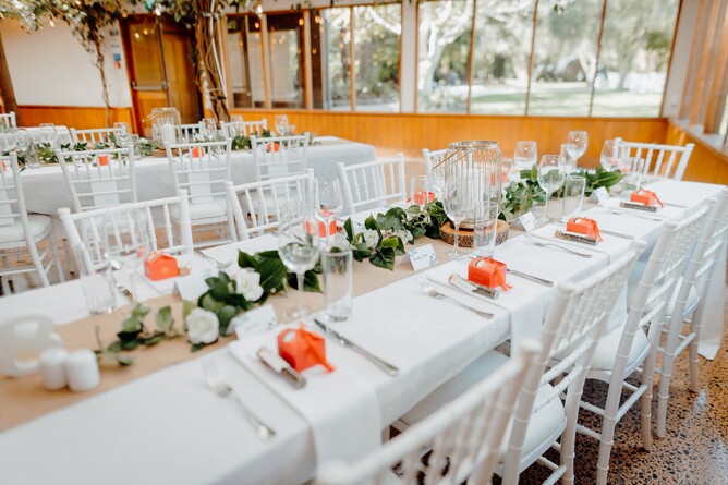 Table setup for wedding reception highlighting individual wedding favours