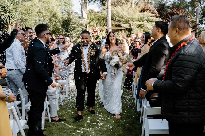 Bride & Groom walking down the aisle after their wedding ceremony at The Palms at Markovina Estate in Kumeu