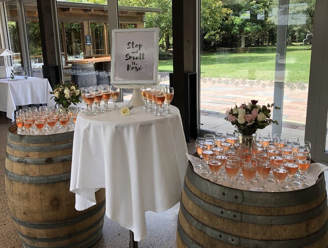 Rosé champagne glasses arranged on top of barrels