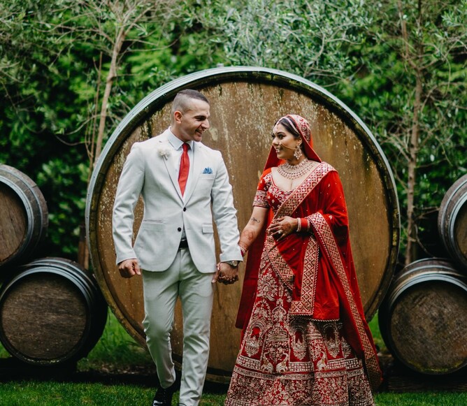 Indian couple posing in front of the Markovina Vineyard Estate barrel