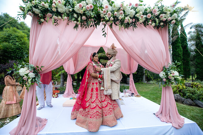 Pink floral mapdap setup for an indian wedding ceremony at Markovina Vineyard Estate in Kumeu