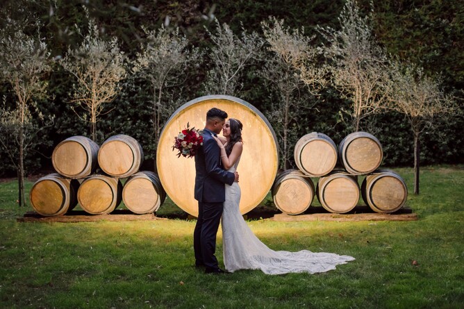 Bride & Groom taking evening couples photo at The Barrels at Markovina Estate in Kumeu