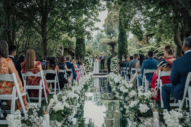 Unique wedding Aisle setup with reflective mirrors and florals at the Barrel Waterfall at Markovina Estate in Kumeu