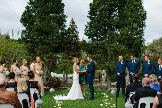 Historical photo of wedding couple having there ceremony at the Two Kauri Trees at Markovina Estate in Kumeu