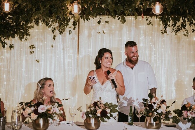 Courtney & Stephen giving a speech at the bridal table