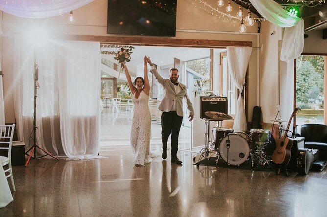 Courtney & Stephen entering the wedding reception the