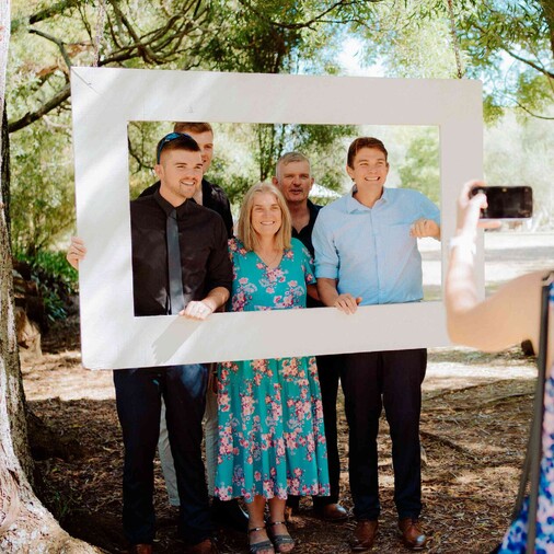 guests posing with picture frame