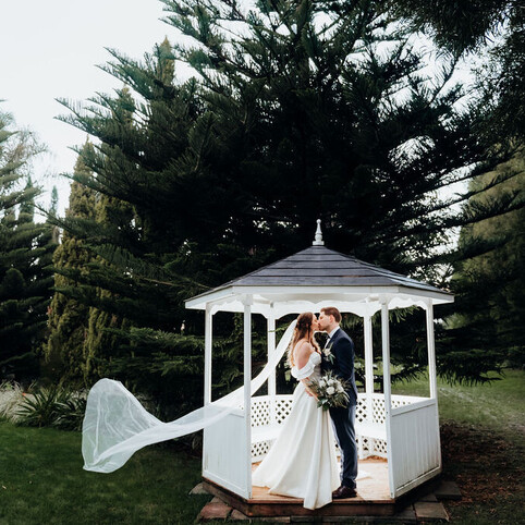 wedding couple kissing under pergola