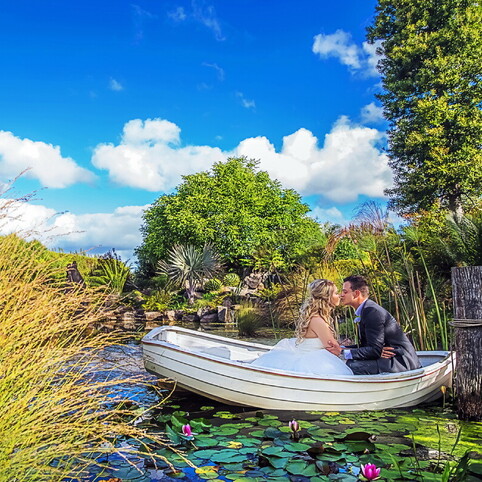 couple kissing on a rowboat