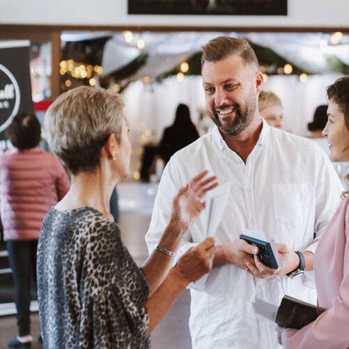 two guest talking at a wedding