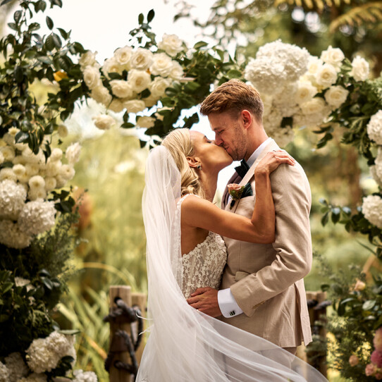 Couple Kissing at their Barrel Waterfall Wedding Ceremony