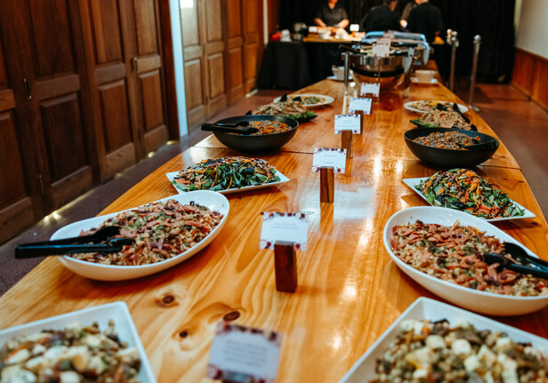 a basket of bread rolls on buffet table