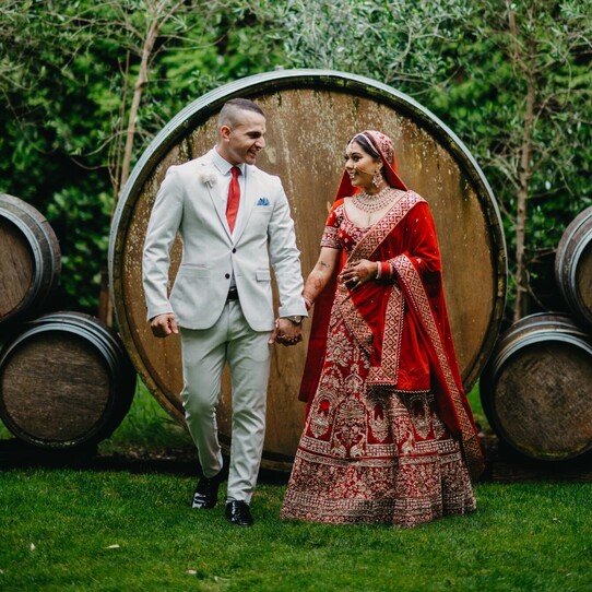 Bride and Groom infront of Barrel Feature