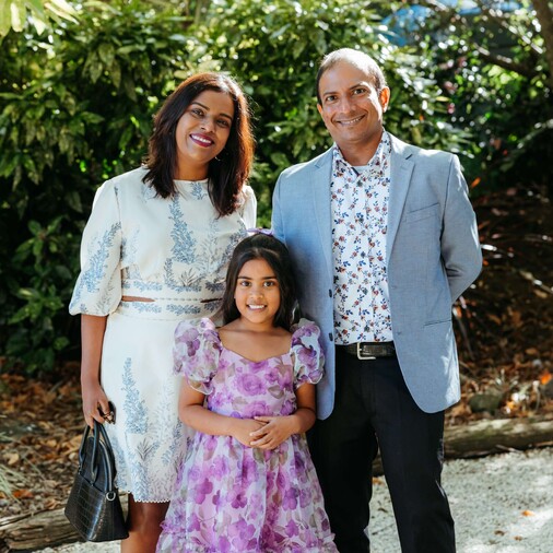 couple with their child at a party