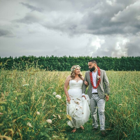 wedding couple walking in a field