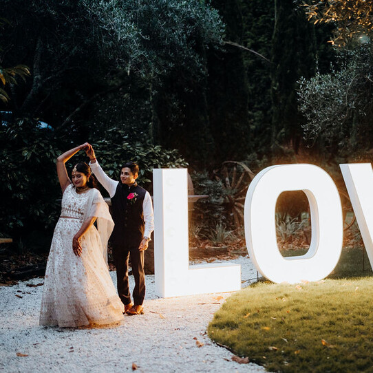 Couple Posing with LOVE Sign