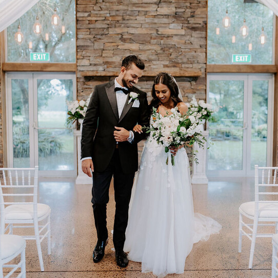 Bride and Groom infront of Stone Fireplace