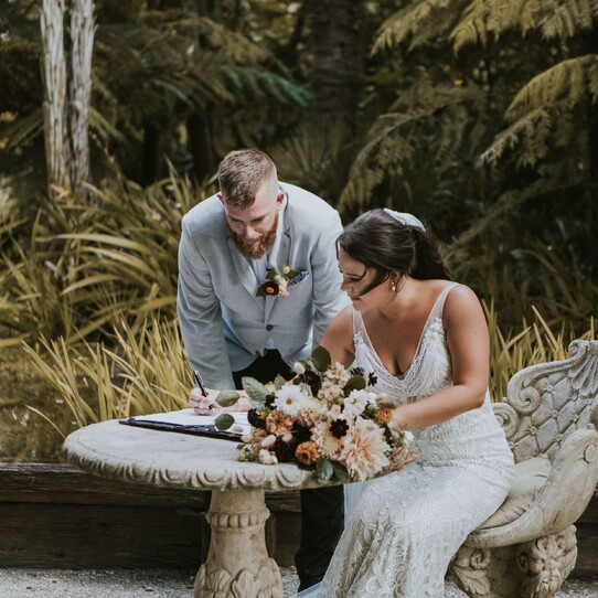 Couple Signing Marriage Certificate at their Barrel Waterfall Wedding Ceremony