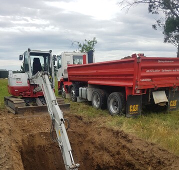 digger creating a large hole with excavation company