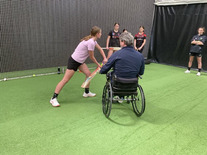 U15 Girls getting batting tips