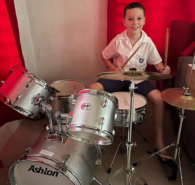 Kelepi cutting a mean beat on the drums.