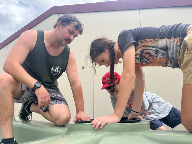 Mr Plumber supervising his minions cleaning the water tank.