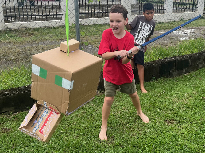 Dutifully destroying a minecraft cat piñata with school friends at his 9th birthday party in March