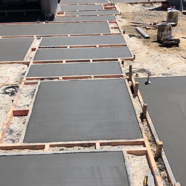 Freshly laid concrete pavers of various rectangles and squares creating a pathway