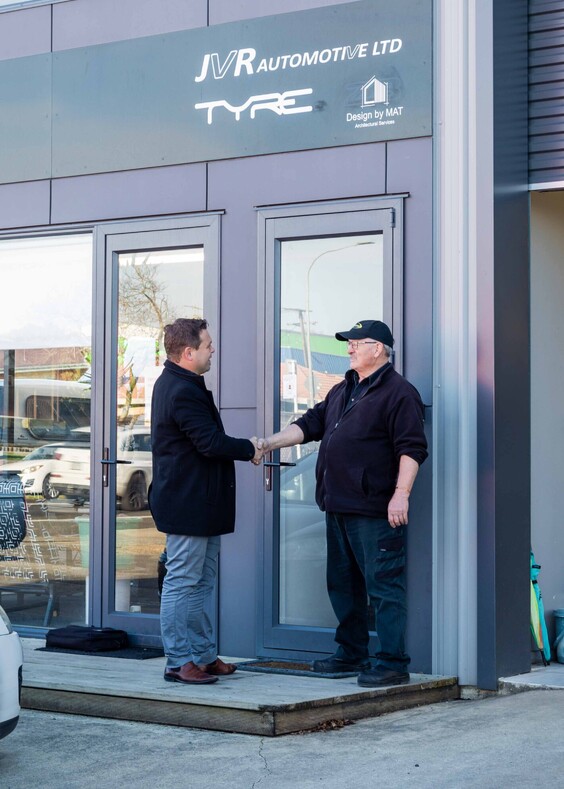 Insurance Adviser shaking hands with a mechanic