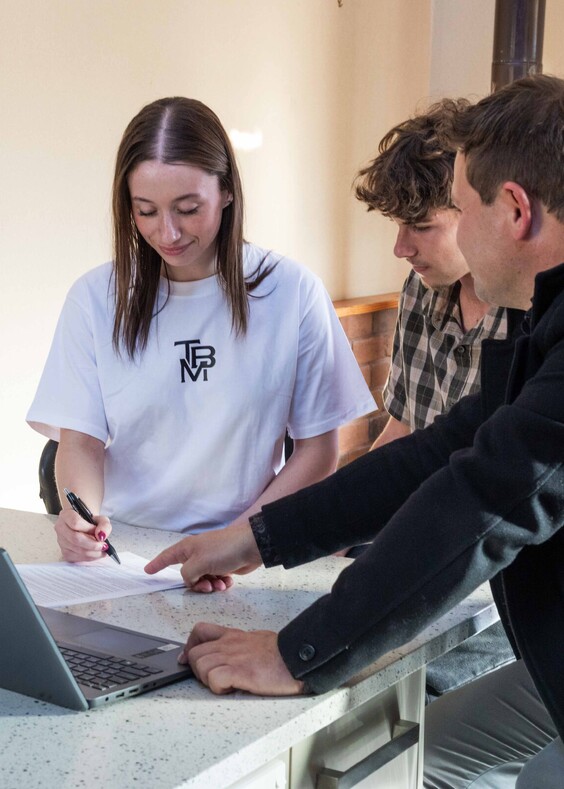 Man and a woman signing a contract for their first home