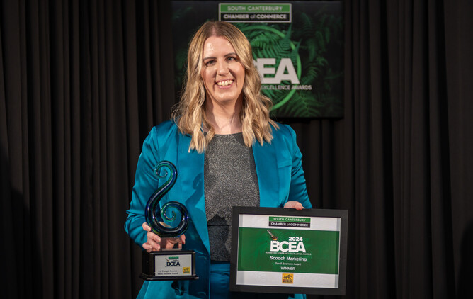 A professional portrait of Tam Johnson, the sole owner and founder of Scooch Marketing, standing with her husband in support of her Timaru-based digital marketing agency. The image reflects Tam's journey in building the business from the ground up over the past 4.5 years, delivering top-notch marketing solutions in South Canterbury.