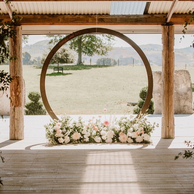 Ceremony space on a wooden deck with a rustic setting at the Red Barn near Cambridge