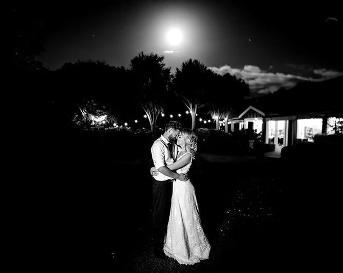 Night shot of a wedding couple under the moon at The Boatshed Wedding venue near Cambridge