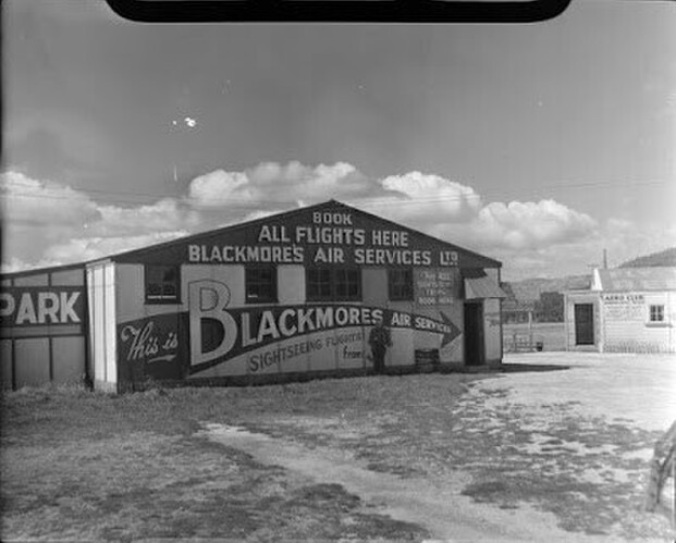 Building of Blackmore's Air Services, Rotorua. Whites Aviation Ltd: Photographs. Ref: WA-19820-F. Alexander Turnbull Library, Wellington, New Zealand. /records/22837762